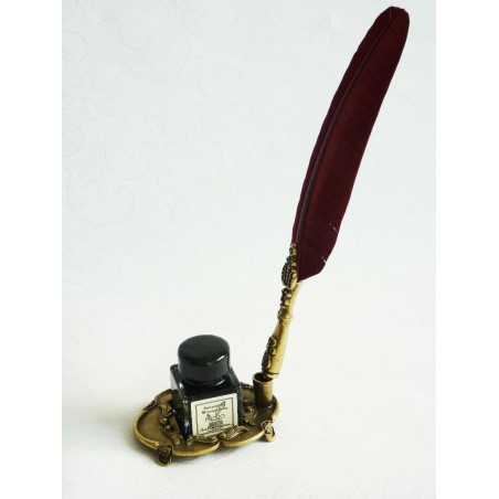 Brown feather and pewter quill with ink bottle and pen holder