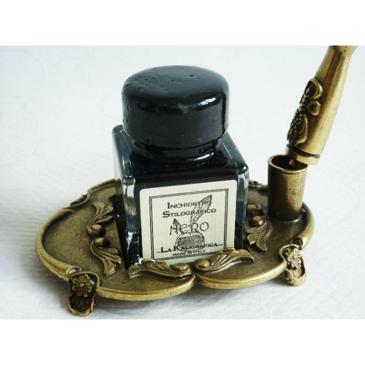 Brown feather and pewter quill with ink bottle and pen holder Brown feather and pewter quill with ink bottle and pen holder
