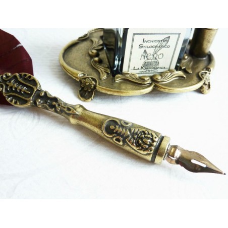 Brown feather and pewter quill with ink bottle and pen holder