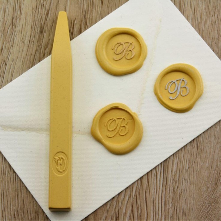 Bright yellow wax seal impression on envelope