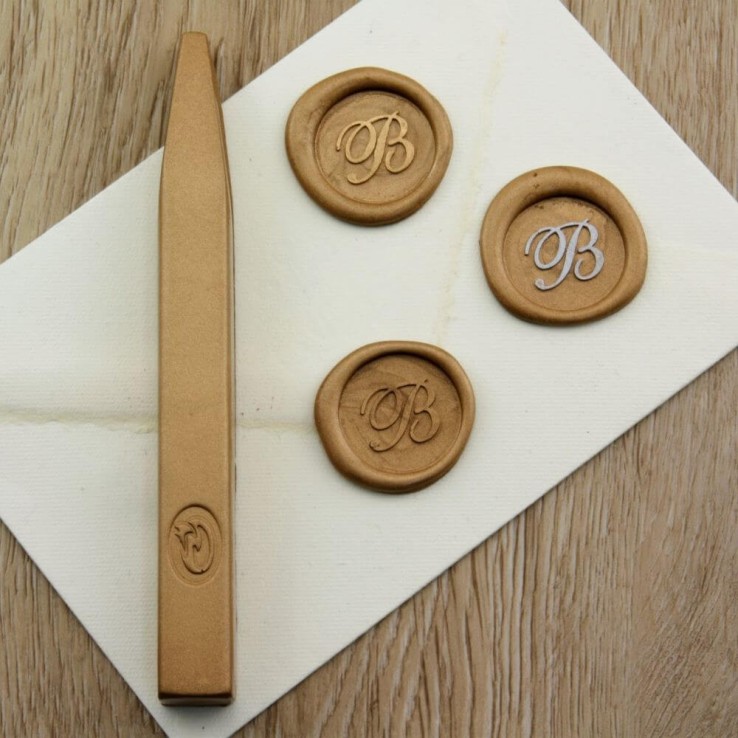 Metallic gold wax seal impression on envelope